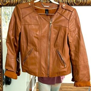 Cinnamon colored leather jacket is buttery soft, but needs repair.